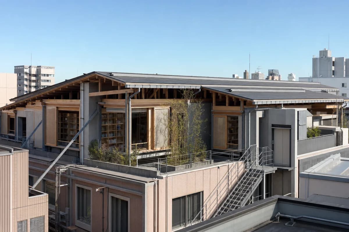 Timber and ceramic reading room on a dense commercial roof.