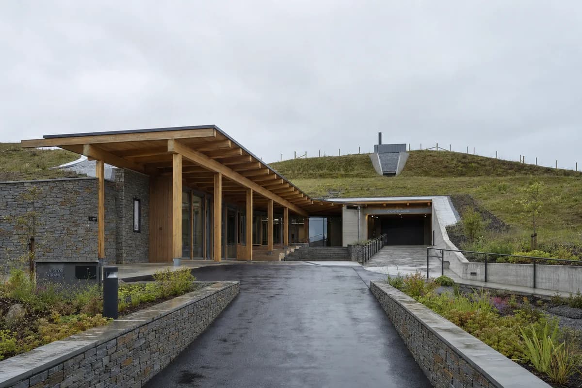 Earth-sheltered seed bank behind a quiet timber public wing.