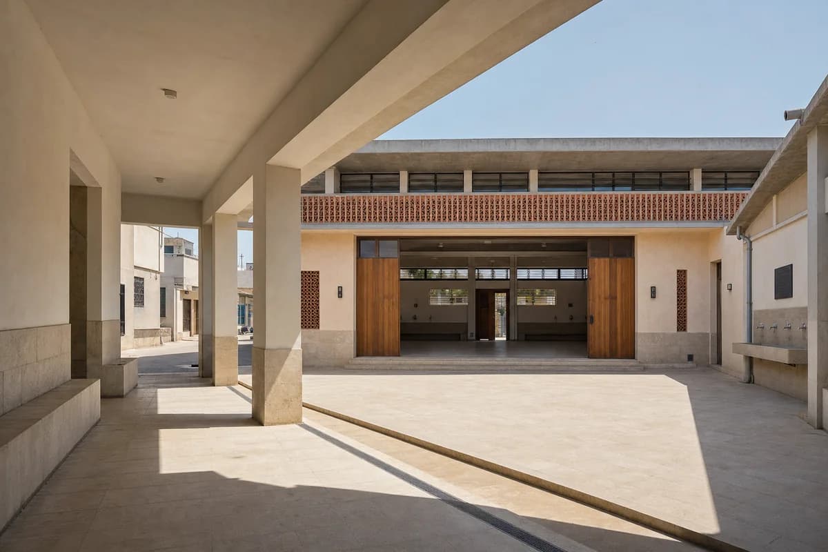 Limestone heat-refuge hall enclosing a deeply shaded Tunis courtyard.