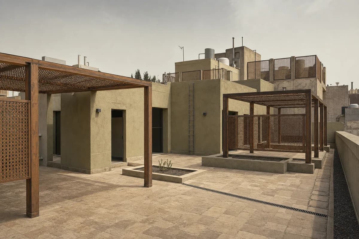 Lime-rendered rooftop community rooms behind wind screens.