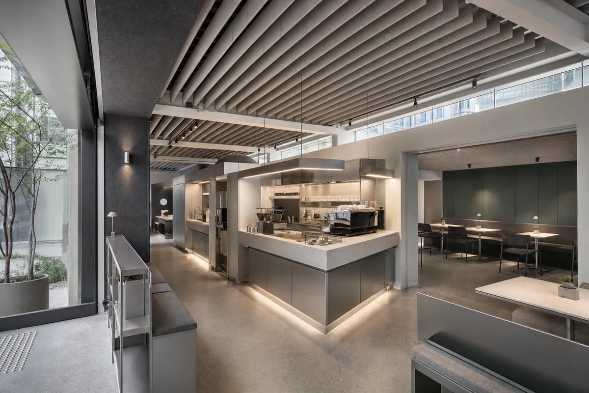 Acoustic Coffee Gallery, gallery cafe organized by a bar and acoustic ceiling defining two quiet seating chambers.