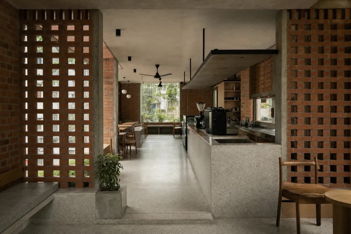 Clay-Screen Coffee House, neighborhood cafe organized by a ventilated clay screen creating a shaded threshold room.