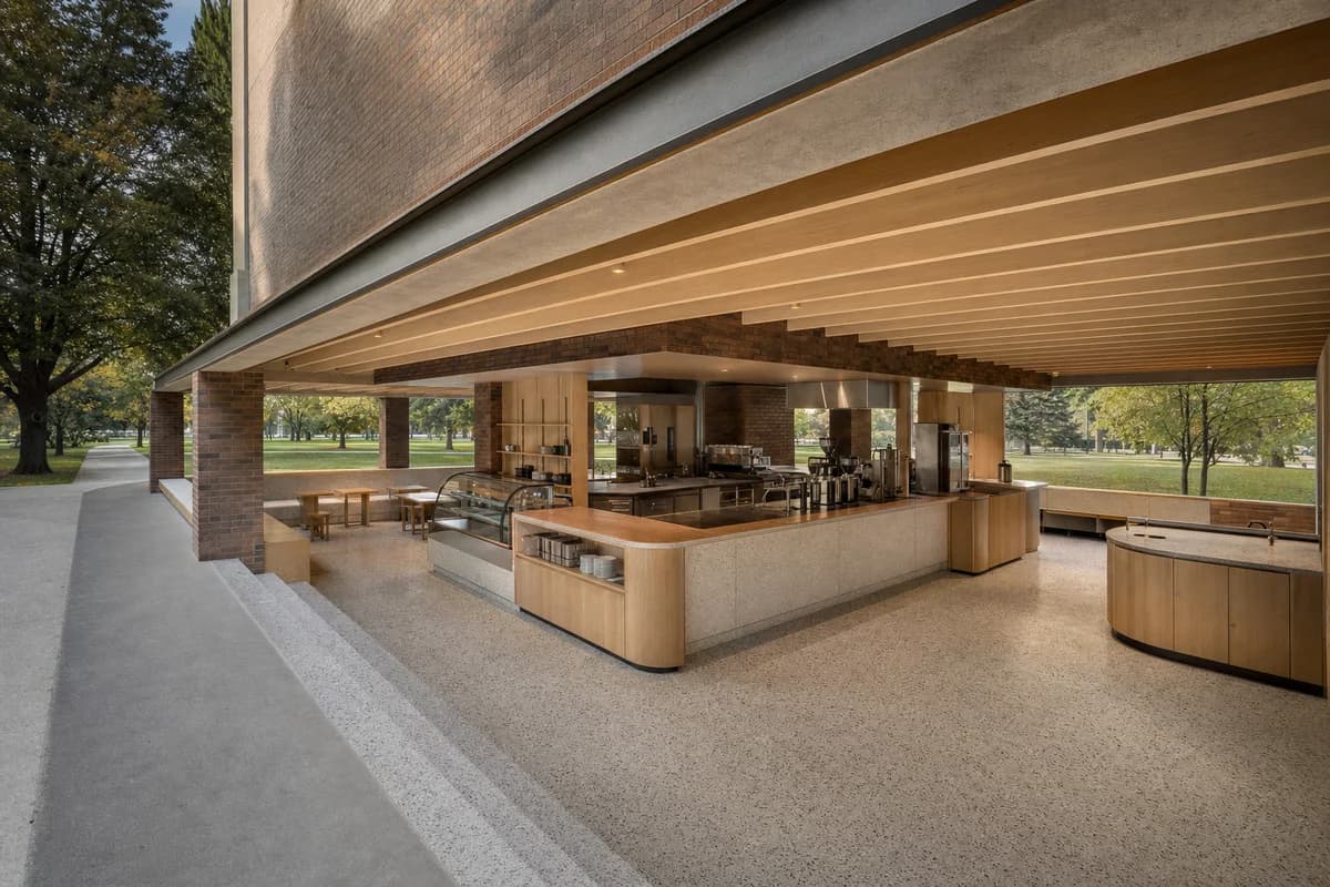 Park-Edge Coffee Pavilion, civic park cafe organized by a low roof and central core creating four protected edges.