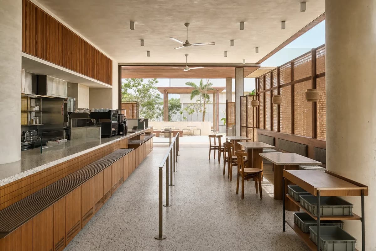 Screen-and-Serve Cafe, community-center cafe organized by replaceable screen panels mediating queue, seating, and shaded court.