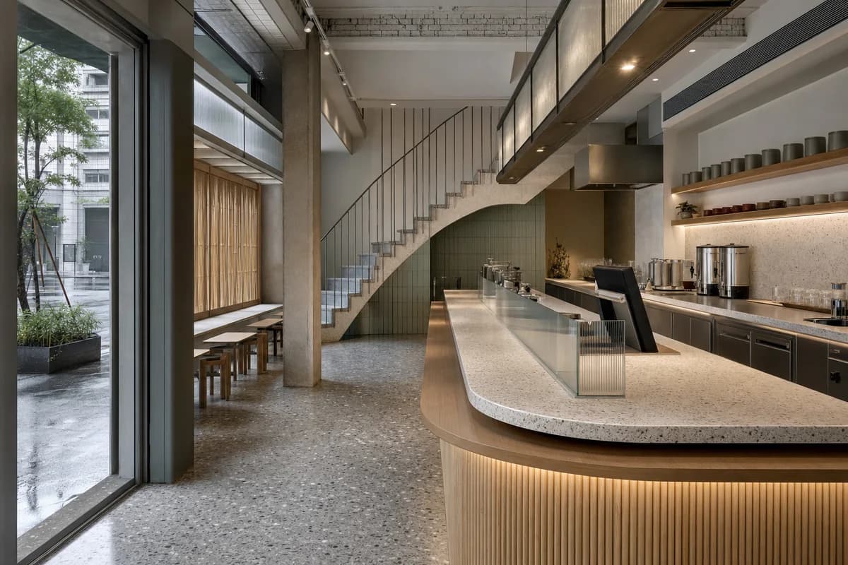 Screened Tea Counter, tea cafe organized by a service counter wrapping a ventilated stair and shaded frontage.