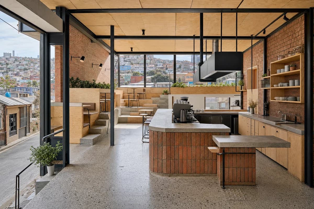Split-Step Coffee Hall, hillside cafe organized by stepped seating following terrain around a compact bar.