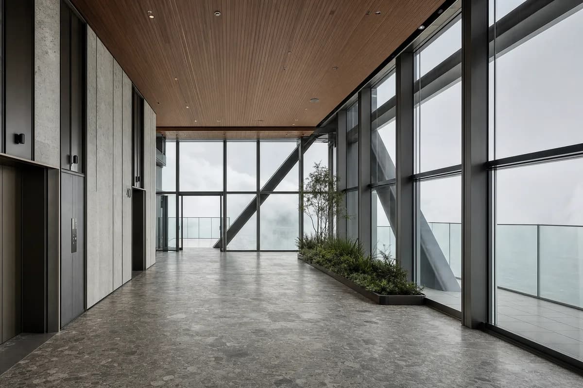 Stone and timber tower sky lobby enclosed by pale low cloud.