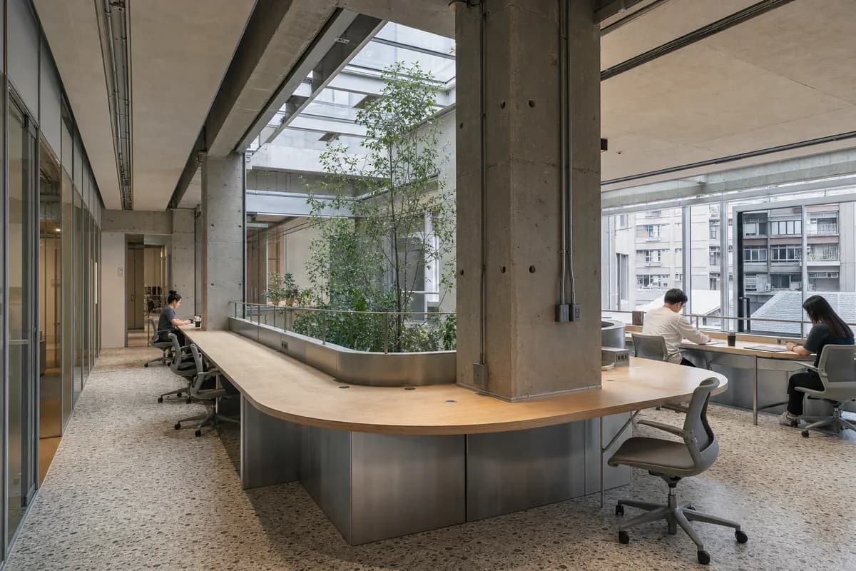 Aluminum Ribbon Desk, furniture shaping coworking room with a continuous desk.