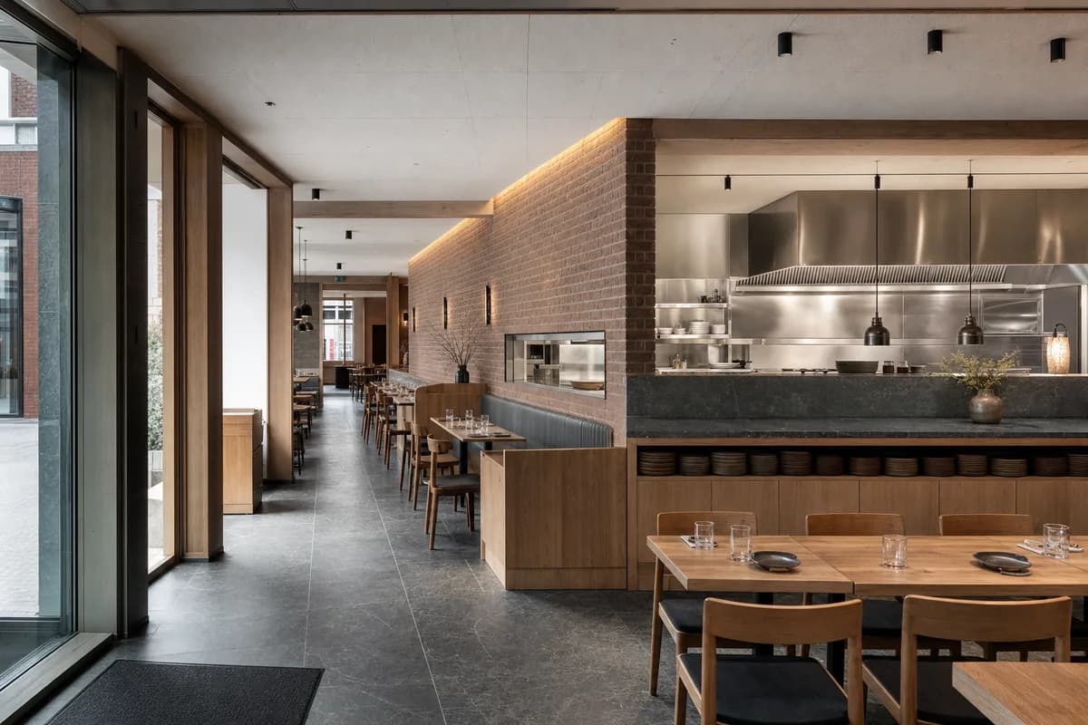 Harbor Stone Dining Room, seafood restaurant organized by an angled masonry wall directing views while shielding service.