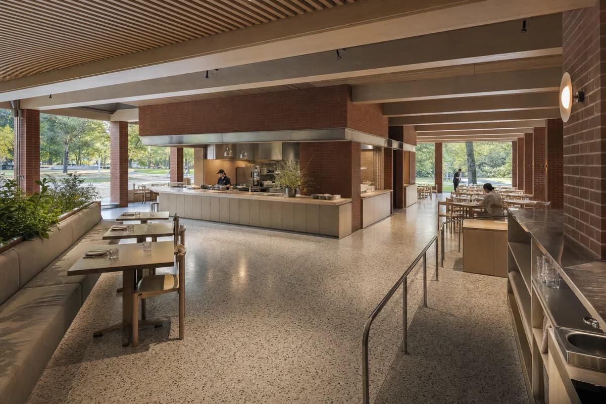 Park-Edge Lunch Pavilion, daytime restaurant organized by a low roof and central service block creating four sheltered dining edges.
