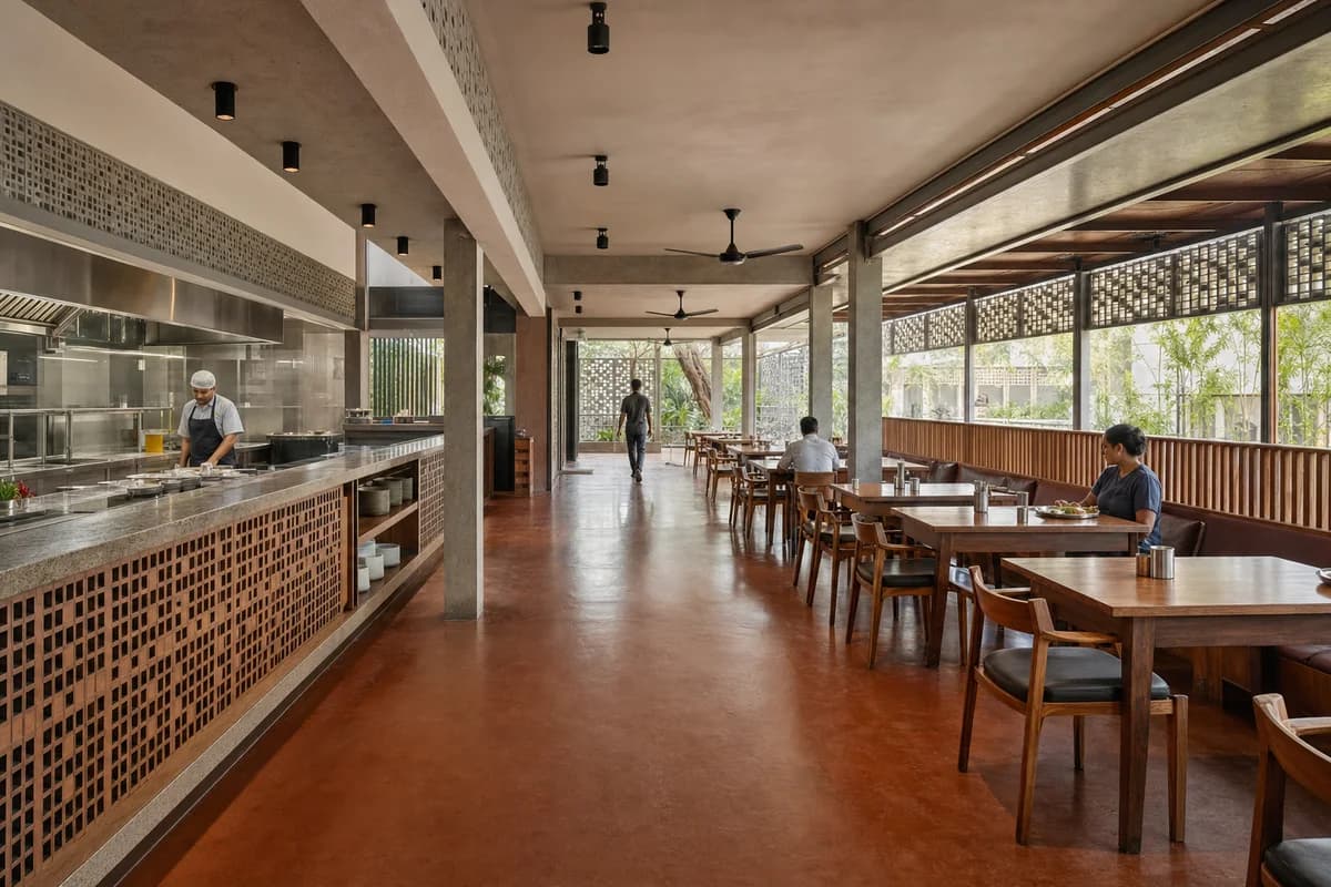 Veranda Meal House, neighborhood restaurant organized by a shaded veranda wrapping kitchen, wash, and dining sequence.