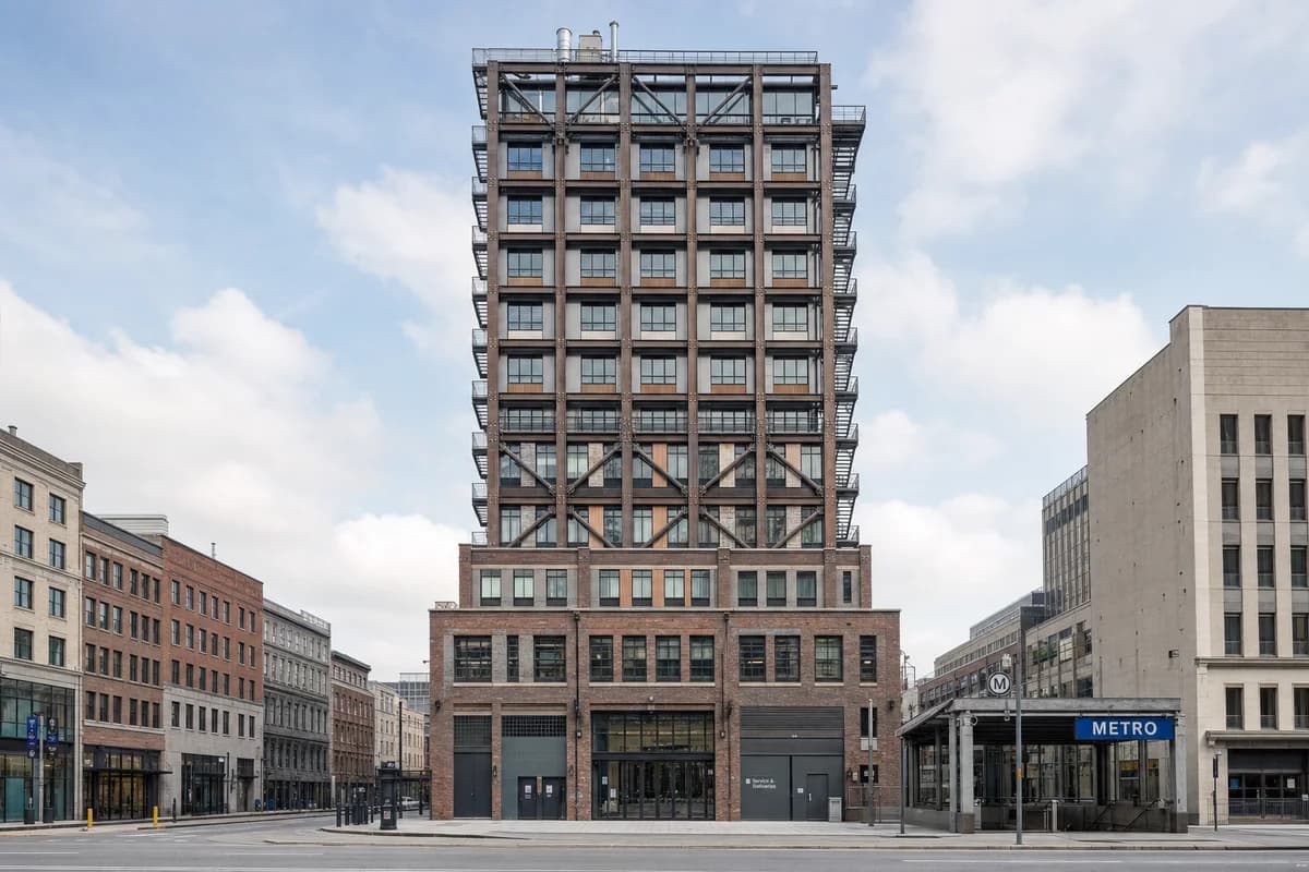 Unoccupied disassemblable sixteen-story tower rising from a dense metro street.