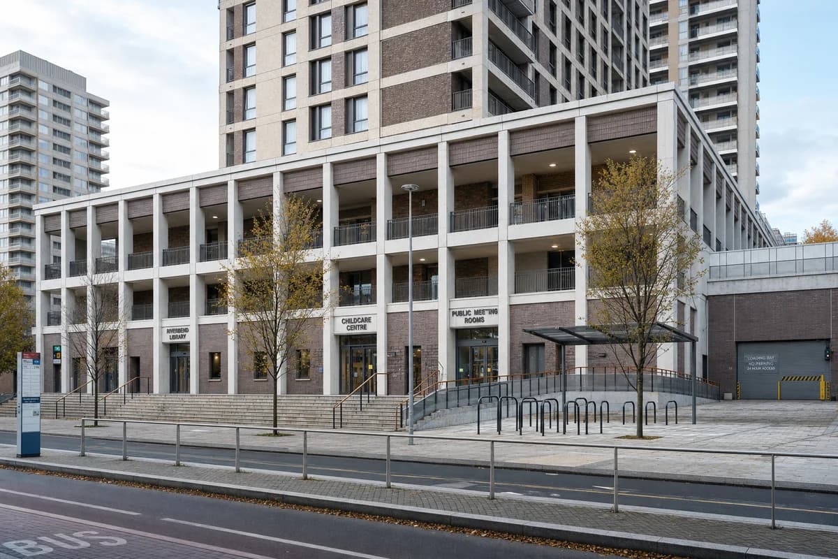 Unoccupied civic podium and sheltered square beneath a housing tower.