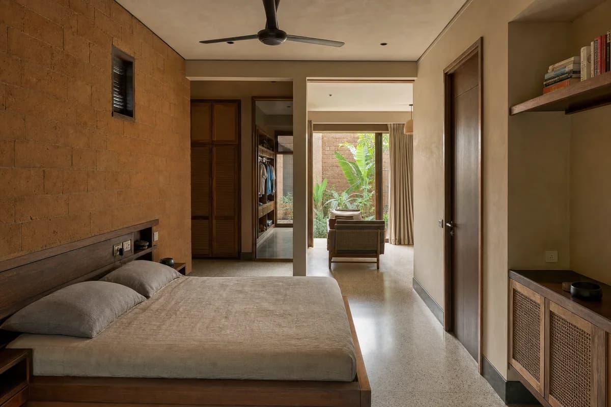 Courtyard Family Suite, multigenerational bedroom suite organized by bedroom, dressing bay, and small sitting room wrapping a shaded court.