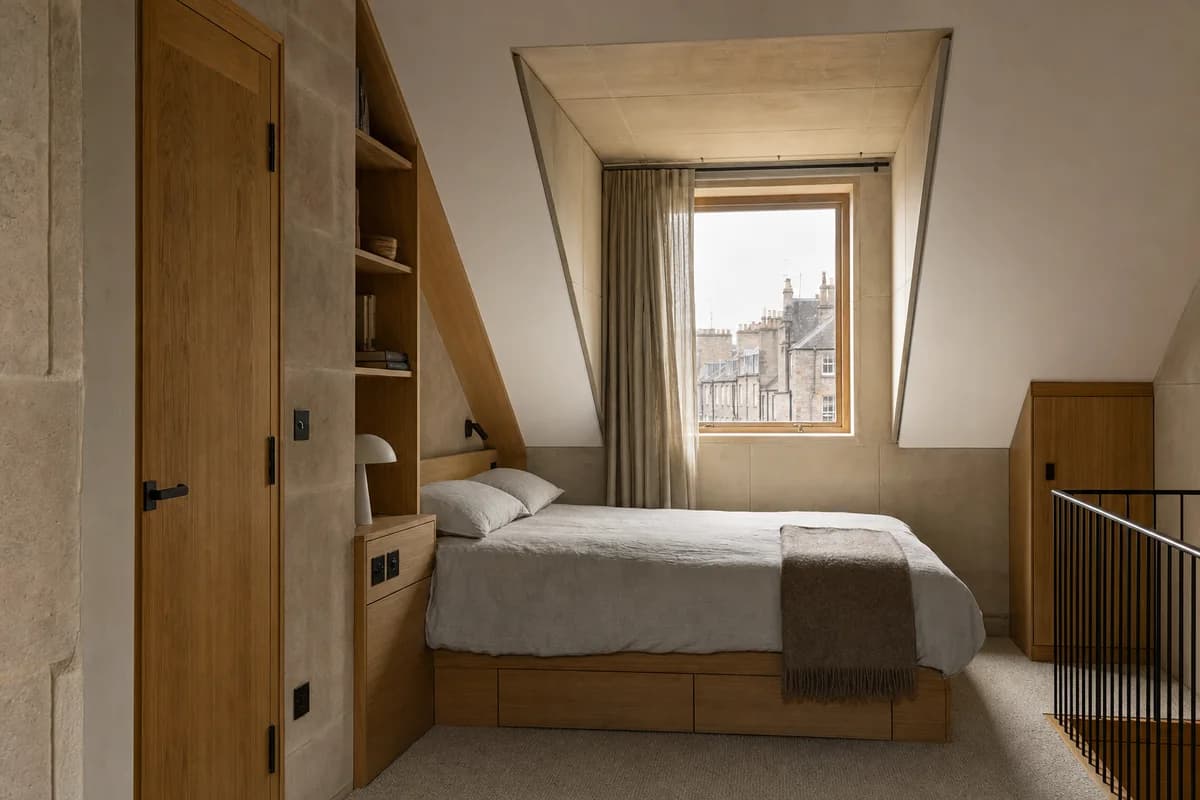 Roof-Edge Bedroom, attic apartment bedroom organized by built-ins regularizing a sloped roof around one dormer.