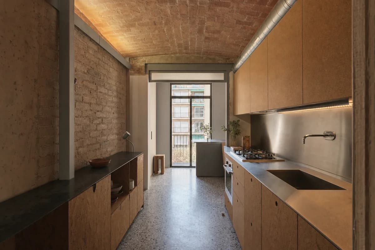 Brick-Vault Service Bay, apartment kitchen shaped by cabinetry fitted beneath a retained shallow structural vault.