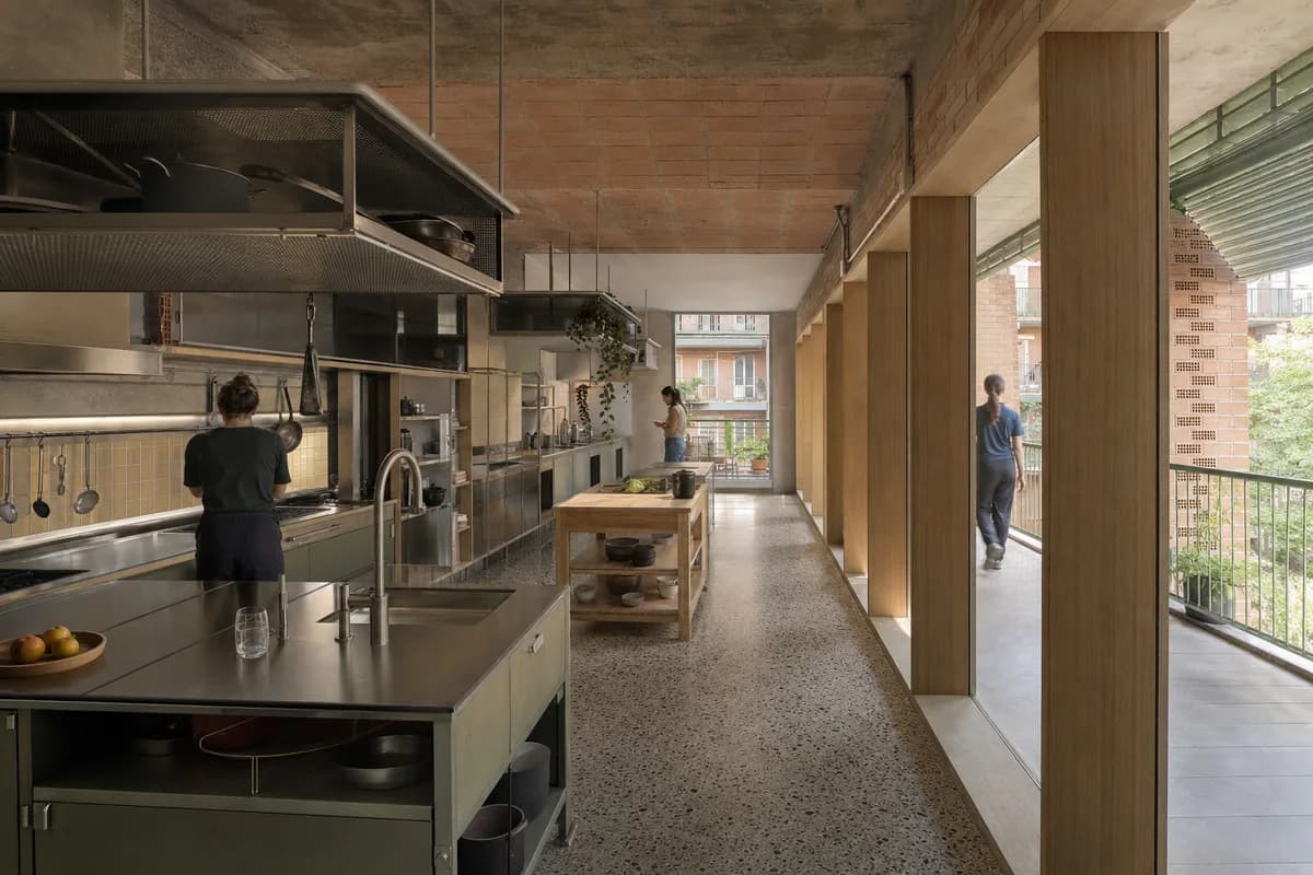 Loggia Kitchen Commons, cooperative housing kitchen shaped by shared cooking bays aligned with a deep communal loggia.