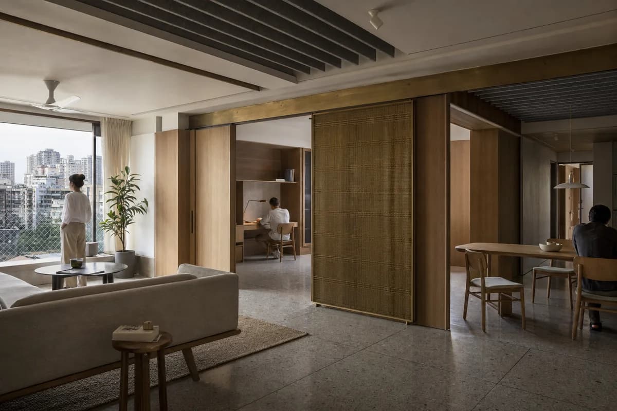 Acoustic Family Hall, large apartment living room organized by ceiling baffles and sliding walls partitioning household uses.
