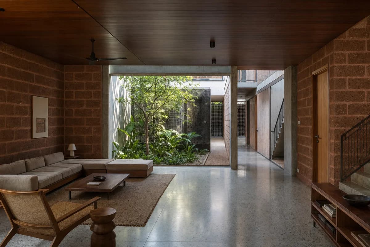 Courtyard Corner Hall, townhouse living room organized by an L-shaped room wrapping a shaded planted court.
