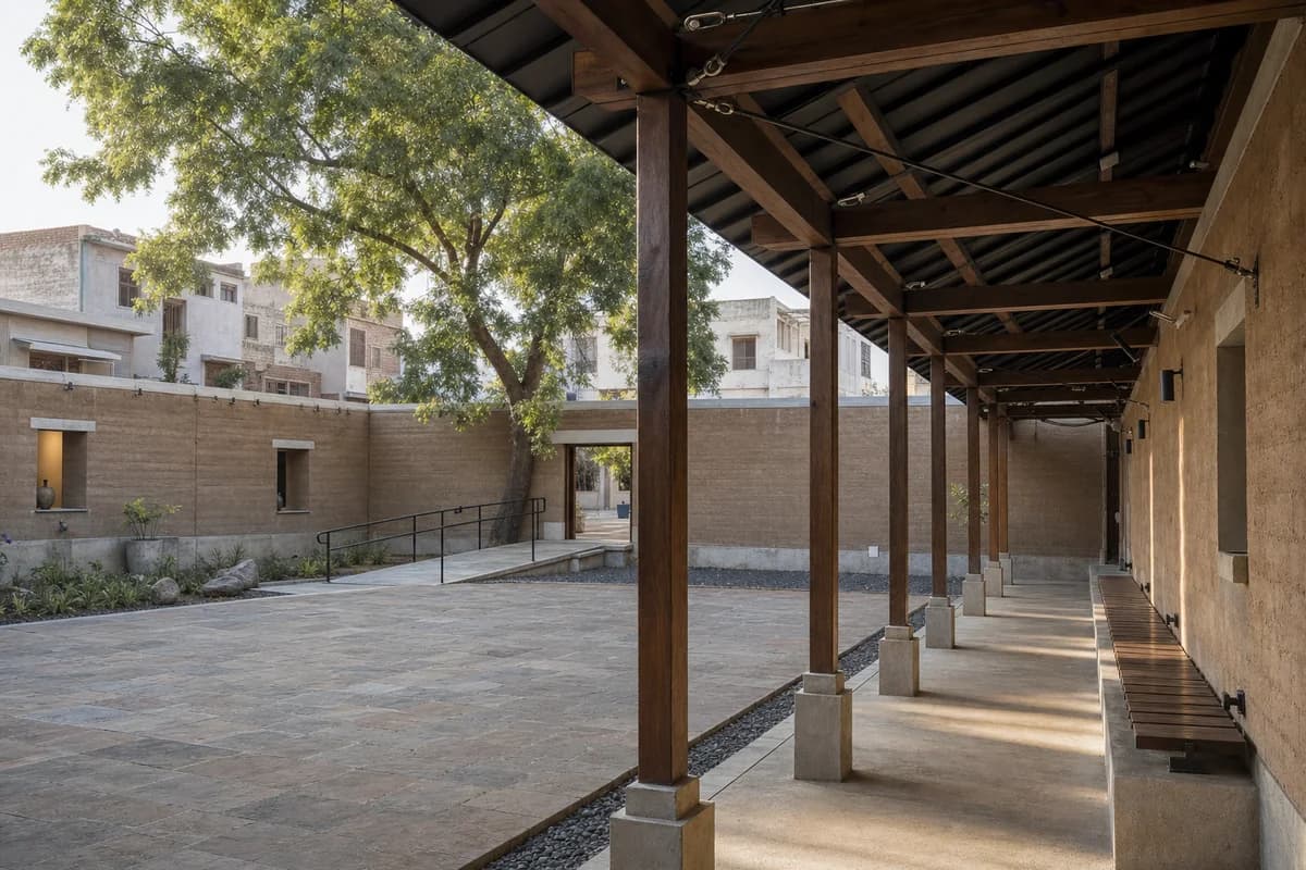 Unoccupied Jaipur earth-block ceramics gallery with a shaded stone garden court.