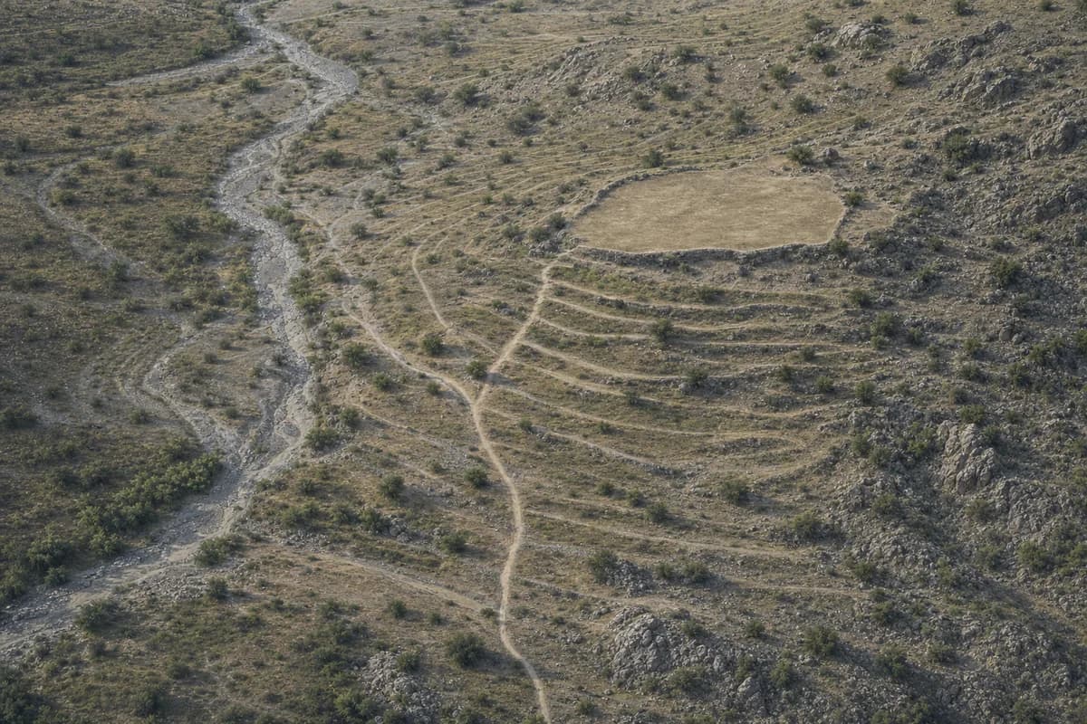 Fictional neutral oblique aerial of a dry seasonal wash