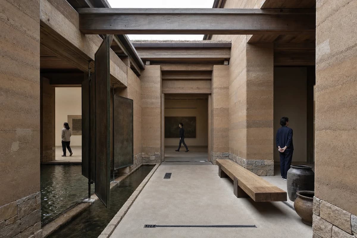 A second candidate of the same earth gallery water court with identical camera, geometry, activity, time, lighting, and conditions.