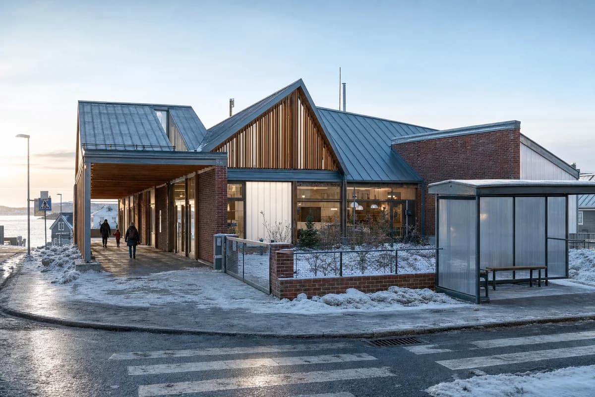 Winter coastal family center around a protected garden court and salt-marked arcade.