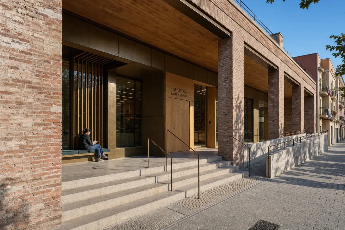 One reader sits beneath a detailed Barcelona library loggia in warm direct sun and a clear blue sky.